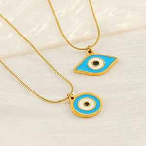 Detail of gold snake chains with round and almond blue evil eye enamel pendants