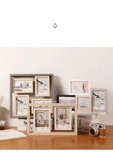 Detail view of multi-aperture wooden photo frames in various wood finishes on a desktop