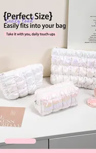 Close-up of holographic iridescent quilted cosmetic bags with wavy stitching detail