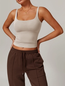 Slim fit beige square neck yoga tank top for women shown on a model against grey background