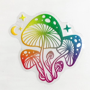 Macro detail of rainbow glitter mushroom suncatcher sticker with moon and stars patterns