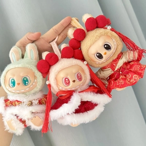 Close-up of three colorful plush dolls in festive red and gold Chinese traditional outfits