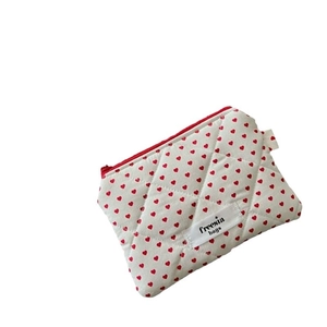 Quilted makeup bag with red hearts and zipper for travel storage organization