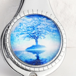 Silver bottle opener keychain featuring a blue tree of life art pattern in crystal glass