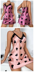 Detail of satin slip dress featuring heart patterns, lace V-neck and adjustable straps
