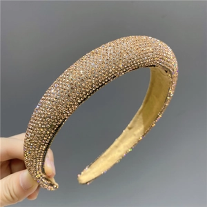 Detail showing hand-held thick champagne gold headband with full rhinestone inlay