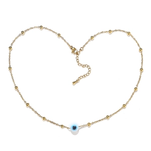 Golden stainless steel necklace with evil eye charm and delicate gold bead details