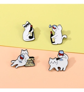 Set of four cartoon white cat enamel pins featuring red wine themes on a warm background