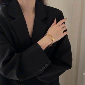 Elegant 18K gold-plated titanium steel heart charm bracelet with a classic toggle clasp