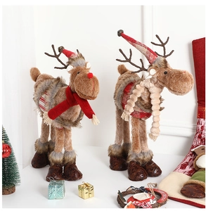 Detail of two Nordic plush Christmas reindeer figurines with festive knitted hats and scarves