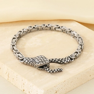 Detail of vintage silver snake head clasp with Byzantine chain and textured scales