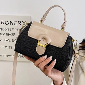 Chic color-block handbag in black pebbled leather and beige smooth flap with gold hardware
