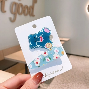 Cute acrylic blue lucky bear and floral hair clips set on card display for girls