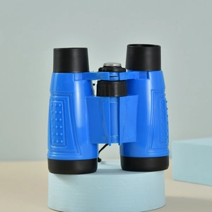Blue and black 6X30 toy binoculars for children with top compass detail on a display stand