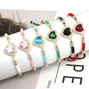 Detail of multi-color woven heart bracelets with gold beads and adjustable cords