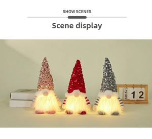Three sequined Christmas gnomes with warm LED lights on a cozy nightstand setup