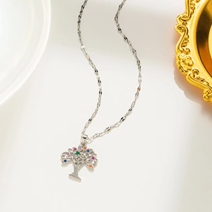 Detailed view of silver tree of life pendant with colorful cubic zirconia inlays