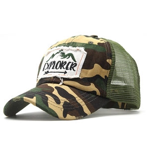 Detail of distressed mesh trucker hat with Explorer patch and camouflage pattern