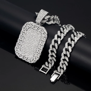 Macro shot of silver hip-hop dog tag pendant and Cuban link chain set with full pavé crystals