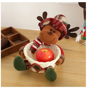 Close-up of a Christmas reindeer plush doll attached to a woven bamboo candy storage basket