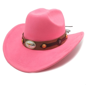Detail of pink suede cowboy hat with bull head emblem and star rivets on leather band
