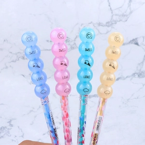 Close-up of four colorful bead-shaped gel pens with sweet heart patterns and icons