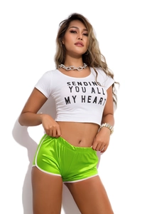 Detail of white crop top with 'SENDING YOU ALL MY HEART' text and green satin shorts