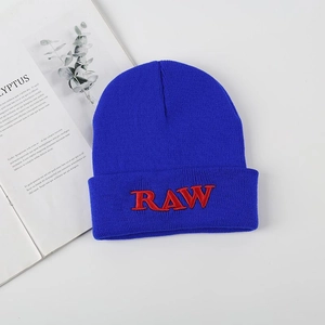 Navy blue knit beanie featuring red RAW embroidery in a stylish street fashion layout