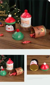 Detailed view of Christmas tin cans with festive hats, penguin and elk cartoon designs