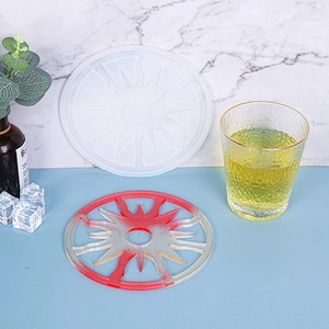 Detail of DIY sunburst silicone mold and red gradient resin coaster with cut-out design