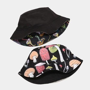 Reversible bucket hat with colorful mushroom print and black solid side for outdoor wear