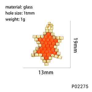 Macro view of a handmade orange and gold glass bead star pendant with dimensions and weight