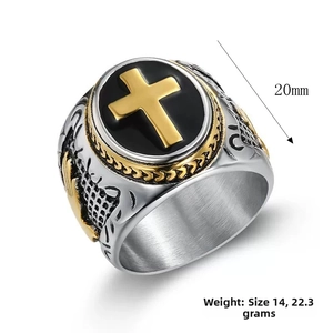 Macro detail of men's signet ring with black circular base and golden cross inlay