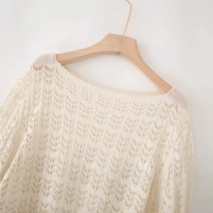 Elegant cream crochet knit long sleeve top with delicate wavy texture on wooden hanger