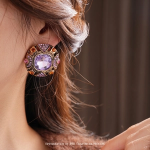 Vintage style square purple gemstone stud earrings with bronze ornate frame on model