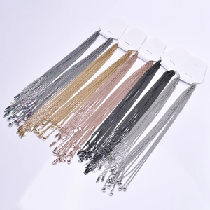 Detailed view of 2.2mm flat link chains in silver, gold, rose gold, and black with lobster clasps