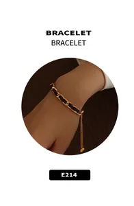 Close-up of woven gold metal and black leather chain bracelet with adjustable bead clasp