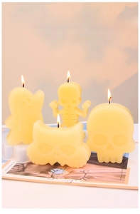 Detail showing cartoon ghost, skull, and cat candles with smooth texture and relief