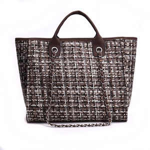Chic tricolor tweed tote bag with leather handles and silver chain strap on white background