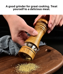 Close-up of hands using a wooden pepper grinder with acrylic window over a cutting board