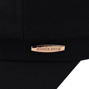 Octagonal newsboy hat detail with rose gold metal plaque and Boonie awng engraving