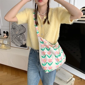 Floral canvas shoulder bag worn by model showing large capacity and fresh spring design
