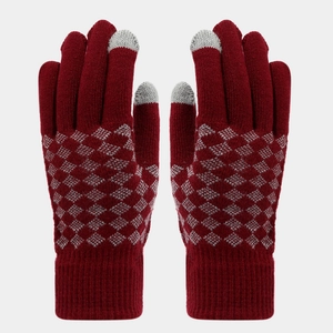 Detail of burgundy knitted gloves with grey diamond pattern and touchscreen fingertips