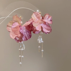 Detail of pink fabric flower earrings with pearl tassels and crystal pendants
