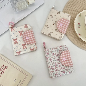 Floral fabric mini wallets with bow prints and checkered snap closure for cards