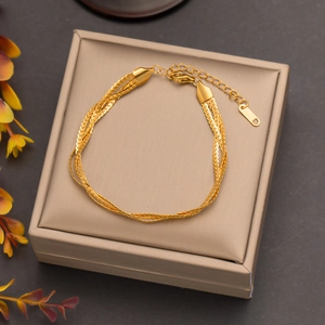 Elegant 18k gold plated titanium steel braided bracelet displayed in a beige jewelry box