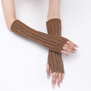 Close-up of caramel cable knit fingerless gloves showing detailed texture and warm yarn