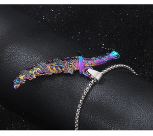 Close-up of rainbow dragon totem sword pendant on silver chain over textured background