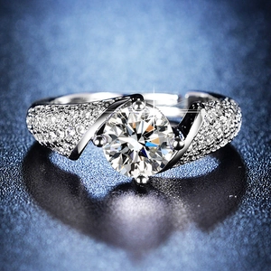 Macro shot of 1ct round-cut classic six-prong wedding ring with diamond-encrusted band