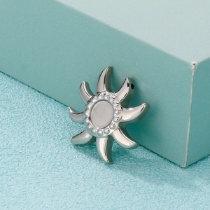Minimalist silver stainless steel sun pendant with sunburst rays on turquoise box